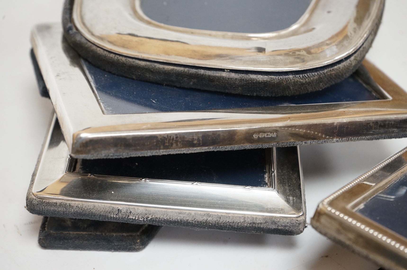 A pair of modern engine turned silver mounted rectangular photograph frames, by Carr's of Sheffield, Sheffield, 1992/3, 14.8cm, together with seven other modern silver mounted photograph frames, largest 23.1cm.